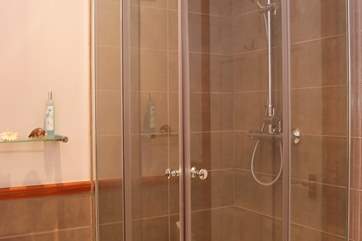 Bedroom 1 has an en suite bathroom with a bath and separate shower cubicle.