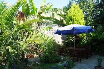 The patio at the rear of the cottage catches the evening sun.