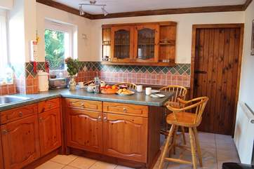 Breakfast can also be eaten at the breakfast-bar in the kitchen with views over the rear patio garden.