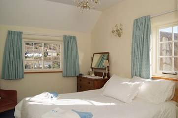 This sunny double bedroom (Bedroom 3) has a double aspect view over the cove.