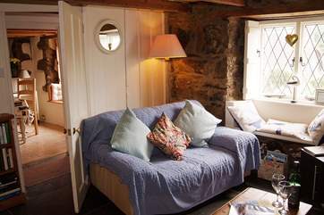 The sitting-room is opposite the dining-room, both of which are either side of the entrance hallway.