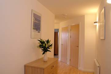 The spacious hallway leads to the bedrooms.