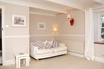 The first sitting-room has a roaring open fire and looks out over the gardens.