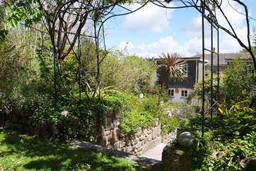 The back of the house, looking down from the well-established gardens.