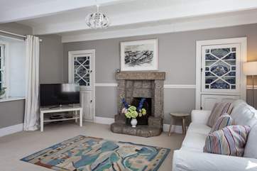 The second sitting room, with a TV and open fire.