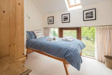 This light filled single bedroom looks over the garden at the back of the cottage.