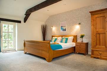 Bedroom One is wonderfully spacious with a Super King sleigh bed