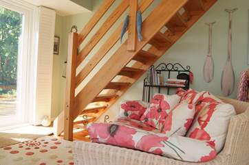 Stairs lead up from the sitting area to the bedroom above.