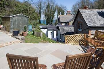 There is a raised patio at the top of the garden with views of the sea.