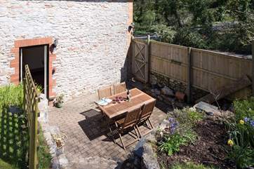Looking down from the raised garden at the patio outside the dining-room.