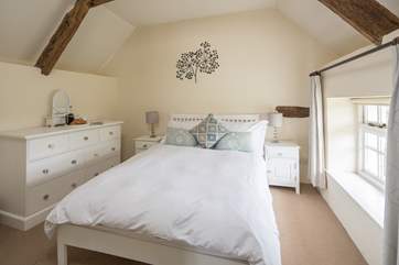 This is the main bedroom (Bedroom 1) with gentle colours and a really comfy bed.