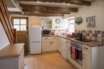 The kitchen is tucked at one end of the open plan ground floor living-area.