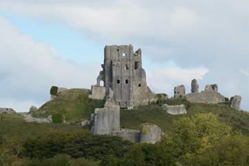 The National Trust's Corfe castle looks out over the pretty village of Corfe, summer concerts and performances are held in the gardens.