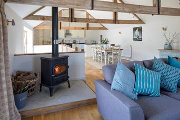 The sitting-area at the opposite end of the the first floor galleried-area, with a wood burner for cosy evenings together.