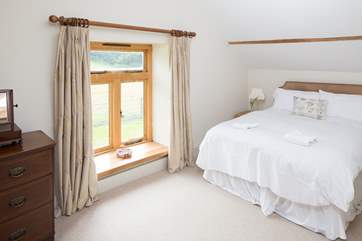 The master bedroom looks out over the little lane to the fields beyond.