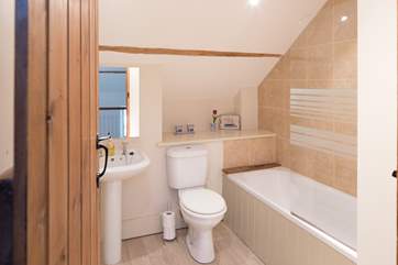 The family bathroom in Dairyman's Cottage is fresh and contemporary.