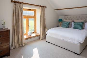 The master bedroom overlooks open fields.