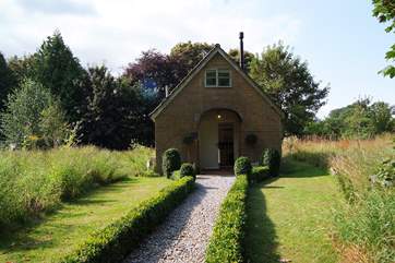This is the view of The Pump House as you pull up into the dedicated parking-area. It is in its own private wildlife meadow with an additional garden to enjoy too.