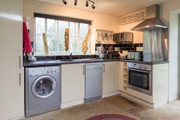 There is a really well-equipped kitchen to one side of this bright and cheerful open plan cottage.