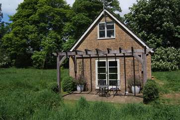 There are French windows out onto the private sun-drenched patio where you can sit beneath the oak pergola and just take in the tranquility.