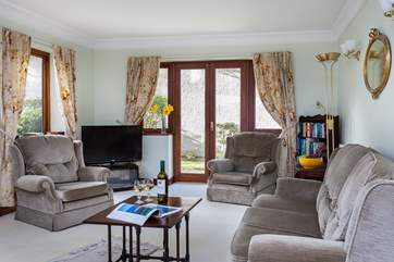 The sitting-area with sliding doors onto the sunny patio area.