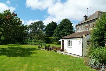 With a pretty, sunny patio outside, the cottage overlooks the beautiful garden.