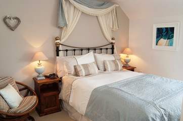 The master bedroom with king-size bed is beautifully furnished.