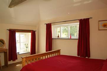 The second bedroom on the first floor with a king size bed and en suite shower room (Bedroom 2).