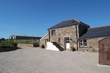 Sunset Barn is to the right of the courtyard, in front of the paddocks where some of the smallholding's animals are kept.