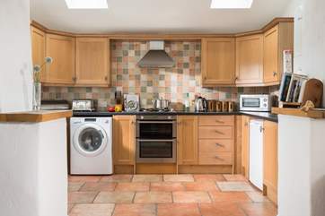 The open plan kitchen is a well equipped sociable space.