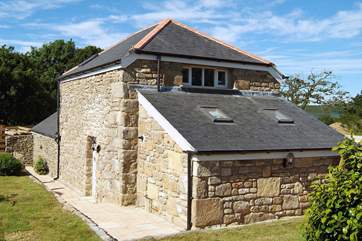 The sunny enclosed garden wraps around the side and rear of this lovely stone barn.