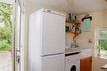 The utility-room, next to the kitchen, leads out to the garden.