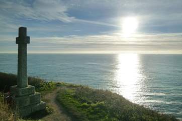 The Celtic cross on the clifftop at sunset.
