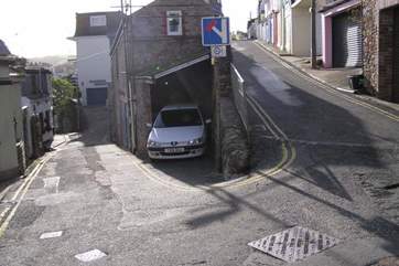 This shows the car sparking space on the right for a small car only and we would recommend reversing in. The shallow steps down to the cottage are three yards down on the left.