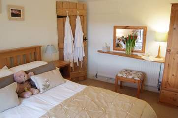 The double bedroom with white bathrobes for your use.