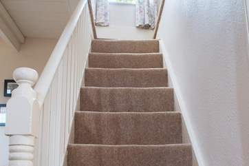The cottage stairs lead up to the two bedrooms, there is a small step up on either side.