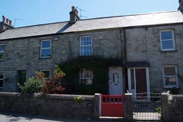 Cobwebs is the cottage with the red gate and white front door.