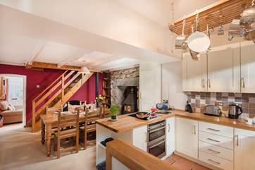 Looking back through to the sitting room from the kitchen with stairs rising to the first floor bedrooms and bathroom
