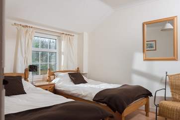 The twin room overlooks the pretty garden to the rear of the cottage.