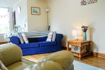 The kitchen-area is to the rear of the cottage, behind the sitting area.