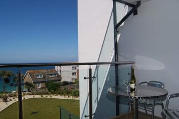 Relax with a glass of wine on the balcony.