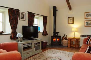 The open plan living-room has a cosy sitting-area.