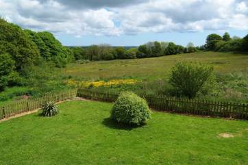 The view from the open plan living-room over the garden and meadows.