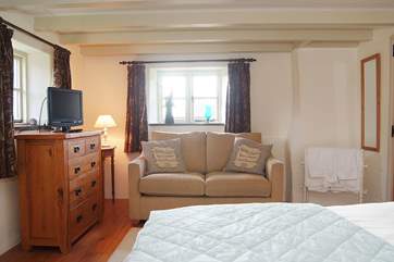 The bedroom has its own sofa and TV.