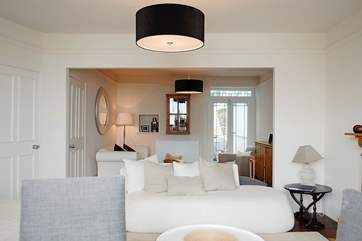 The sitting-room leads out to the glass-roofed dining-area.