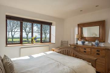This lovely bedroom is furnished with solid wooden furniture and fresh linens.