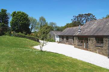 The sunny patio is opposite the cottage, in the orchard across the driveway.