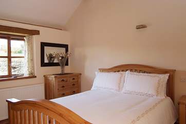 The double bedroom (Bedroom 1) has a beautiful oak king-size bed.