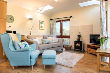 The woodburner makes this a great retreat all year round. Patio doors lead out to the garden