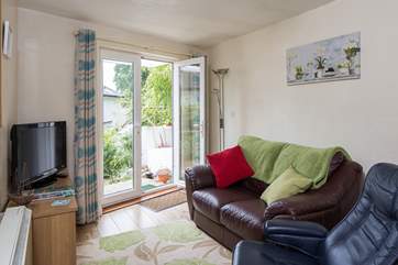The little sitting-area has a flat screen television with a Blu-ray DVD player and French windows opening onto the private terrace.